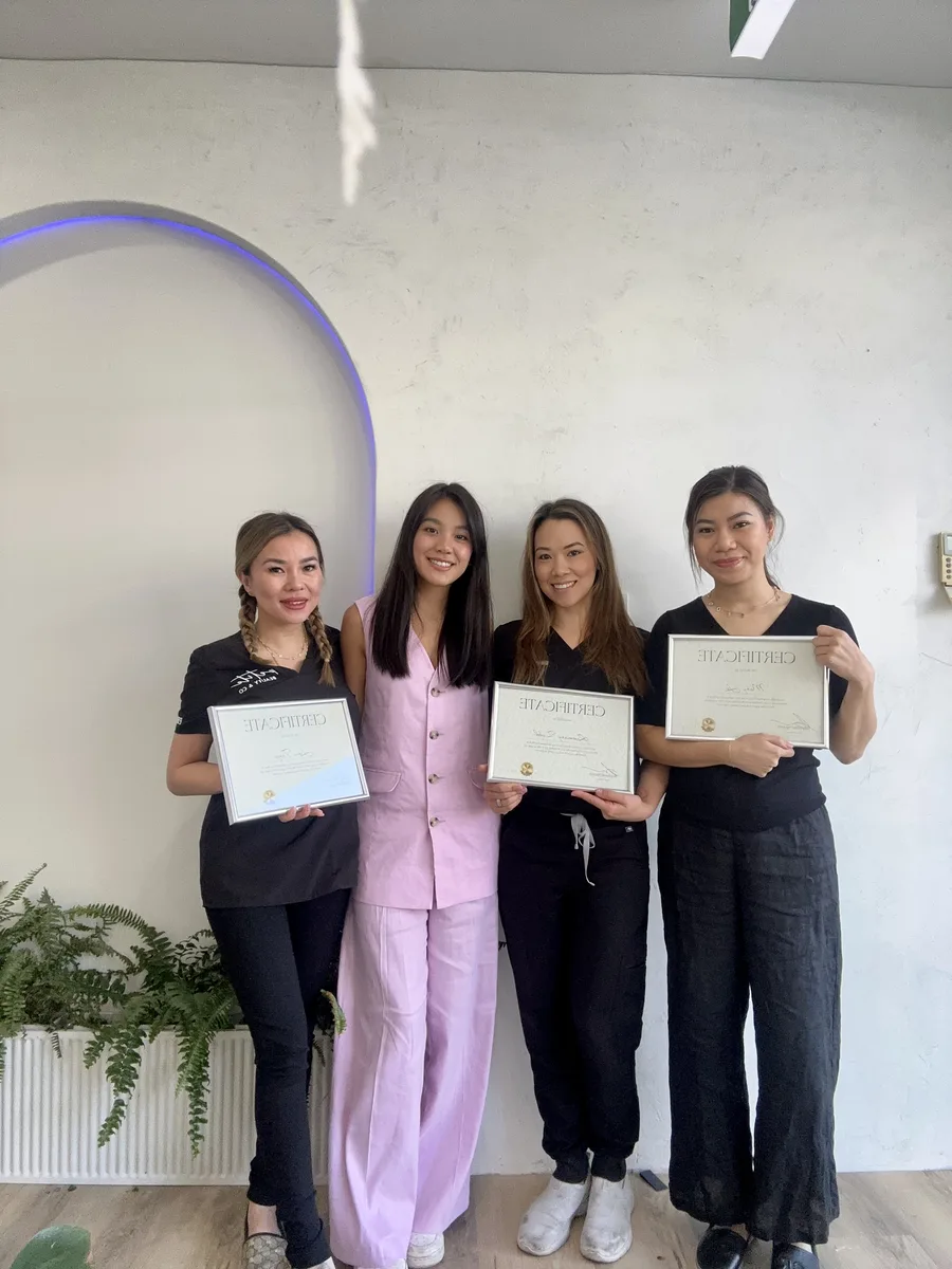 Graduates holding their certificates