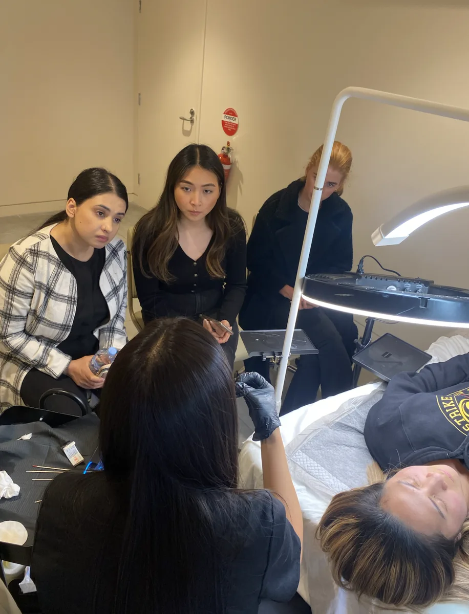 Students observing a live lip procedure